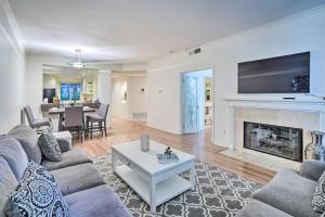 a living room with a couch and a fireplace at Serene Irvine Retreat with Heated Pool Access! in Irvine