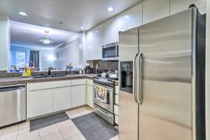 a kitchen with stainless steel appliances and white cabinets at Serene Irvine Retreat with Heated Pool Access! in Irvine