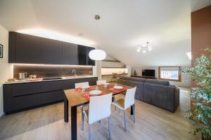 a kitchen and living room with a table and chairs at Villa Santa Maria in Lovero Valtellino