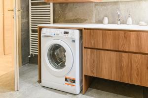 a washing machine in a kitchen next to a sink at Villa Santa Maria in Lovero Valtellino