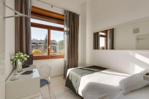 Un pat sau paturi într-o cameră la Hotel Darival Nomentana