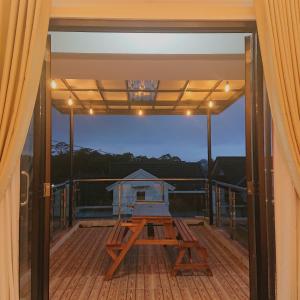 a screened porch with a picnic table on the deck at Sapphire Village Guesthouse in Rempawah