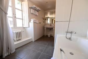 a bathroom with a tub and a sink and a window at Auberge Bretonne in La Roche-Bernard