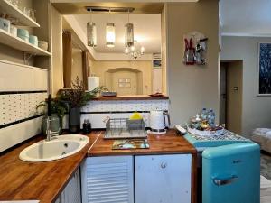 a kitchen with a sink and a blue refrigerator at Apartament Majowa in Jelenia Góra