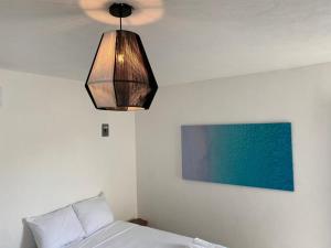 Postel nebo postele na pokoji v ubytování Casa Colibrí El Cuyo