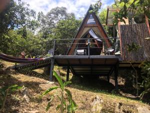 a play structure with a hammock and a house at Glamping Laguna Sagrada in Bobadilla
