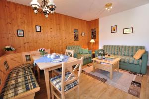 a living room with a table and a couch at Bergblick-Seitz in Fischen +3 photos