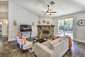 a living room with a couch and a fireplace at Airy Scottsdale Oasis with Pool and Putting Green in Scottsdale