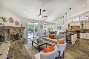 a living room with a couch and a fireplace at Airy Scottsdale Oasis with Pool and Putting Green in Scottsdale