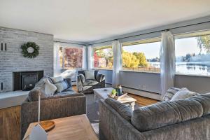 a living room with two couches and a fireplace at Lakefront Seattle Area House with Private Deck! in Lynnwood