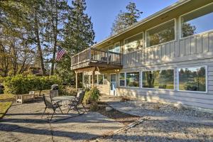 a house with a table and chairs in front of it at Lakefront Seattle Area House with Private Deck! in Lynnwood