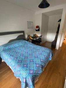 um quarto com uma cama com uma colcha azul em Descanso garantizado! em Montevidéu