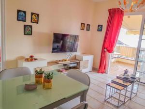 a living room with a green table and chairs at Lovely Apartment in Tenerife South in Chayofa