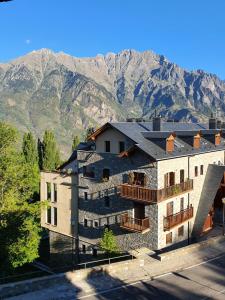 a building with balconies and mountains in the background at Rincón de Cerler in Cerler