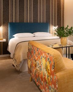 - une chambre avec un lit, un canapé et une chaise dans l'établissement Wanderlust, by Bolhão Residences, à Porto