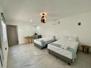 Postel nebo postele na pokoji v ubytování Casa Colibrí El Cuyo