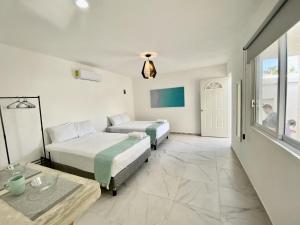 Postel nebo postele na pokoji v ubytování Casa Colibrí El Cuyo