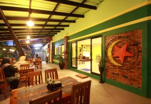 a restaurant with a brick wall with a star on the wall at Bida Daree Resort in Ao Nang Beach