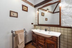a bathroom with a sink and a mirror at Casa Camino del Dobra, Centro de Cantabria in Viérnoles +41 photos