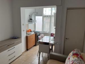 a kitchen with a table and a dining room at Apartament Maria in Călimăneşti