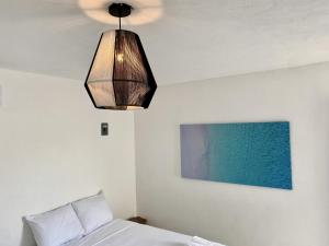 Postel nebo postele na pokoji v ubytování Casa Colibrí El Cuyo