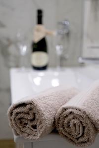 a towel on a counter with a bottle of wine at Apartmaji 5KA in Velika Loka