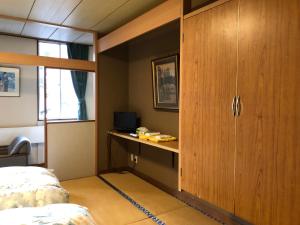 Postel nebo postele na pokoji v ubytování Petit Hotel Yukikkoso