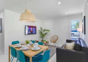 uma sala de jantar com uma mesa e cadeiras azuis em Fantastic Brand New 3BD Duplex In Miami em Miami