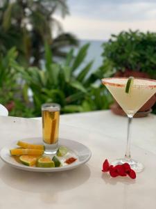 a drink and a plate of food on a table at Villas Fasol Huatulco in Santa Cruz Huatulco