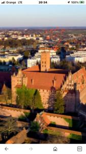 a view of a city with a large building at Apartament Centrum Malbork in Malbork