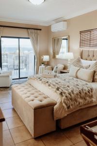 a large bedroom with a large bed and a balcony at Mountain View Guesthouse in Vanrhynsdorp