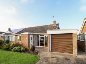 a brick house with a garage at Acre View in Mablethorpe