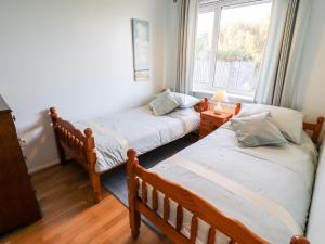 a room with two twin beds and a window at Acre View in Mablethorpe