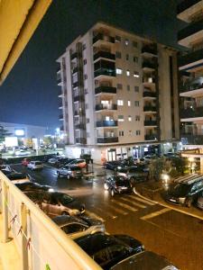 a parking lot with cars parked in front of a building at Apartment Bono 2 City Kvart in Podgorica