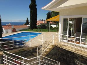 a house with a swimming pool and a patio at Villa Hansen in Garajau - Cristo Rei in Caniço