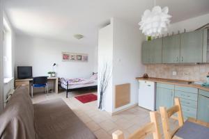 a kitchen and a living room with a dining room at Happy Apartments - Economy in Wrocław
