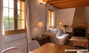 a living room with a couch and a table at Casa Reme Sant Francesc - Formentera Natural in Sant Francesc Xavier