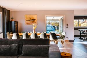 a living room with a couch and a table at Grande maison avec piscine et jacuzzi à la campagne in Desvres