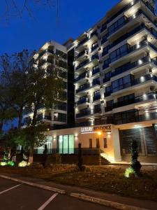 a large apartment building with a building at night at SAS 2 Luxury Apartments in Mamaia