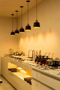 a kitchen with a counter with many pots and pans at Pousada Águas de Maragogi in Maragogi