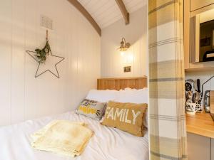 a bedroom with a bed with two pillows on it at The Swaledale Hut - Uk40151 in Rathmell