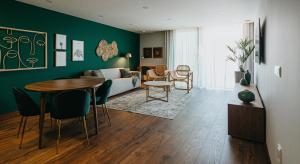 a living room with a couch and a table and chairs at XPT Águeda - Boutique Apartments in Águeda