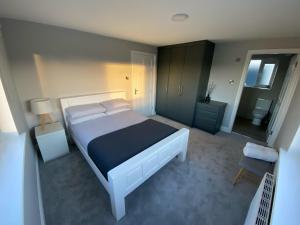 a bedroom with a large bed and a bathroom at Sunny Hill View in Lahinch