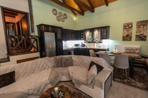 a bedroom with a large bed and a kitchen at Ονειροπαγιδα in Karpenisi