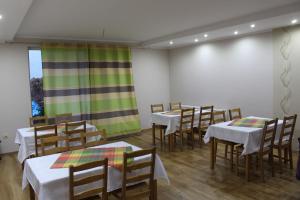 a group of tables and chairs in a room at Zajazd Jagnar in Trzcianka