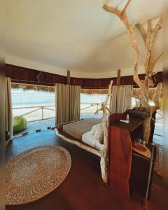 a bedroom with a bed in a room with a table at 7 Beaufort - Kitesurf Pousada in Itarema