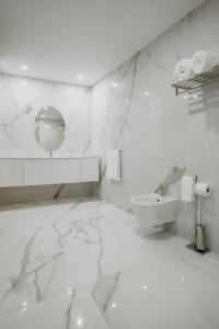 a white bathroom with a sink and a toilet at XPT Águeda - Boutique Apartments in Águeda