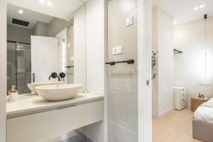 a white bathroom with a sink and a shower at NEW Sophisticated apartment with balcony & city views by REMS in Málaga