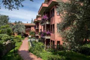 a pink building with flowers on the balconies at Sundia By Liberty Suncity in Oludeniz