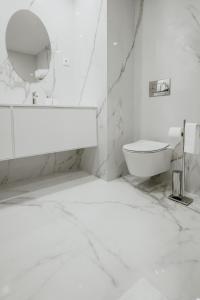 a white bathroom with a toilet and a mirror at XPT Águeda - Boutique Apartments in Águeda